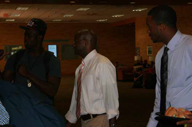 A group of men walking in a room