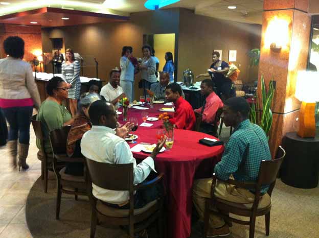 A group of people sitting around a round table