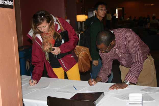 People signing papers