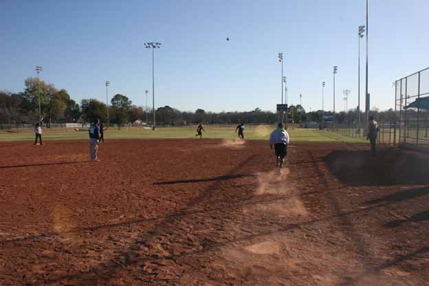 A group of people playing Kickball