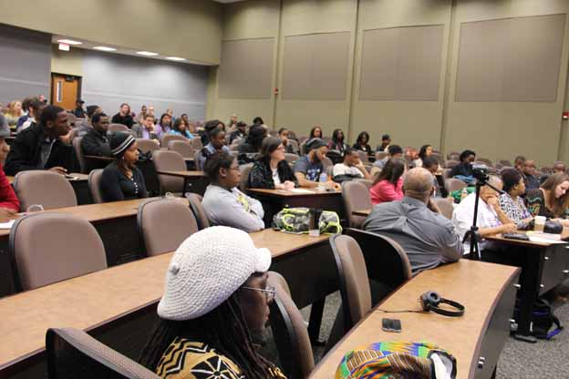 A group of people sitting in a lecture hall