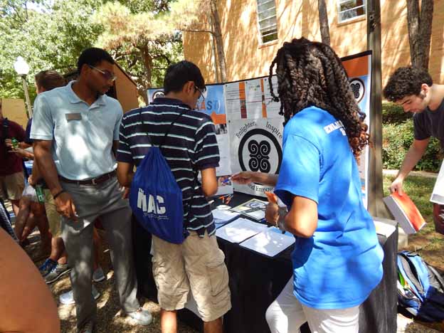 A group of people looking at a poster