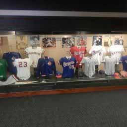 A display case with jerseys on it