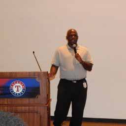 A person standing at a podium speaking into a microphone