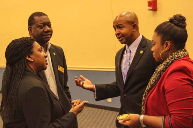 A group of people in suits having a discussion