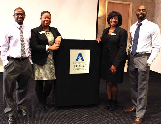 A group of people standing next to a podium posing for a photo
