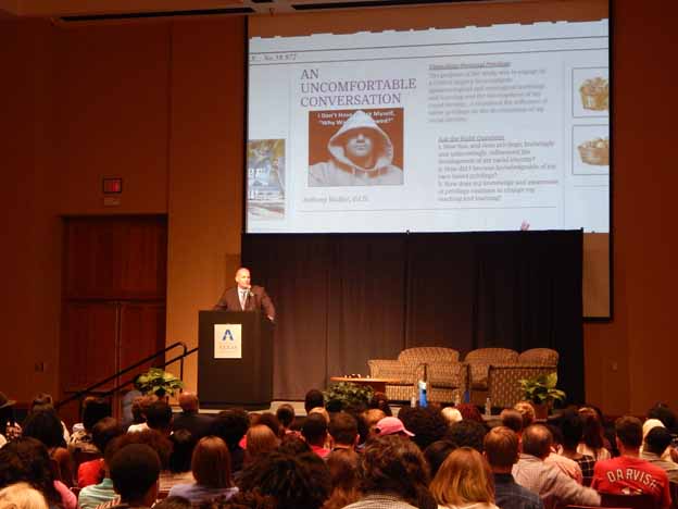 A person standing at a podium giving a presentation