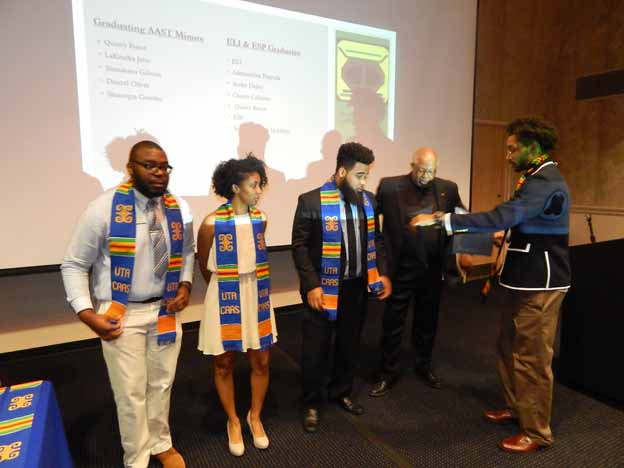 A group of people standing in front of a projector screen