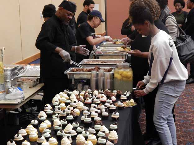A group of people serving food