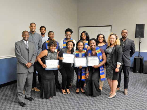 A group of people holding certificates posing for a photo