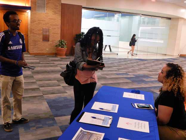A person standing next to a registration table