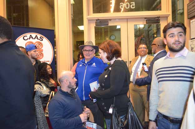 A group of people standing in front of a glass door